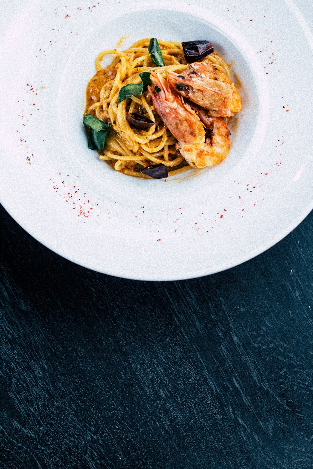 shrimp pasta in white bowl