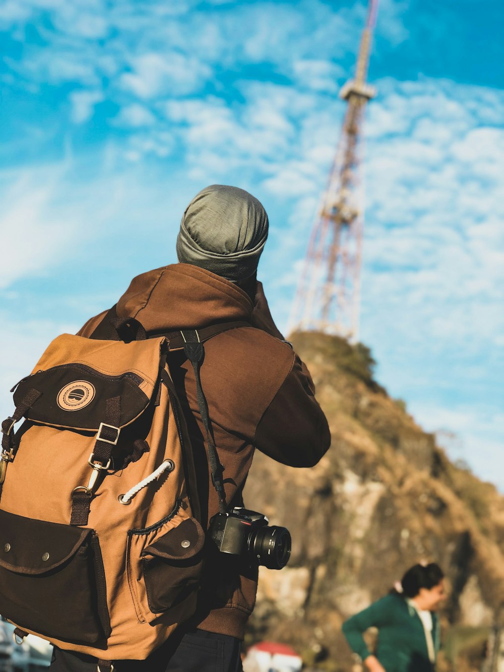 man taking photo near table under blue sky