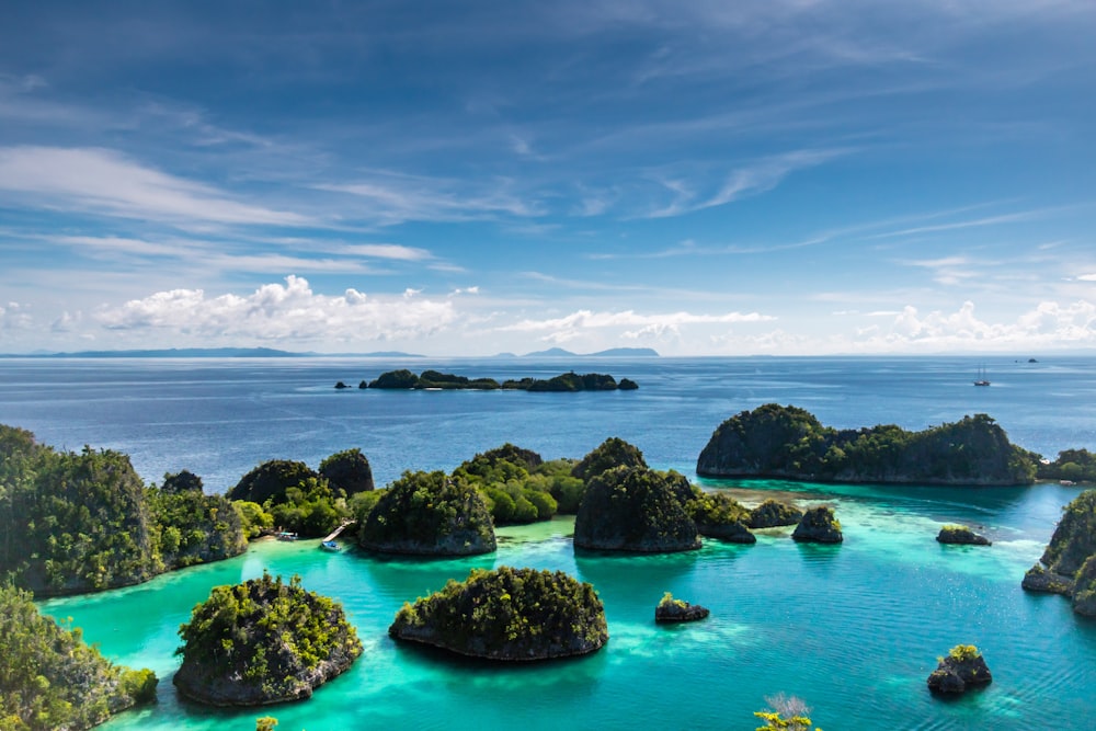 islets surrounded by body of water during daytime