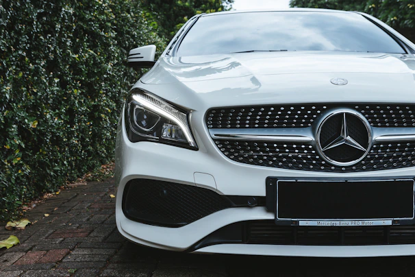 Flagship J8 parked in front of a modern luxury villa with lush greenery