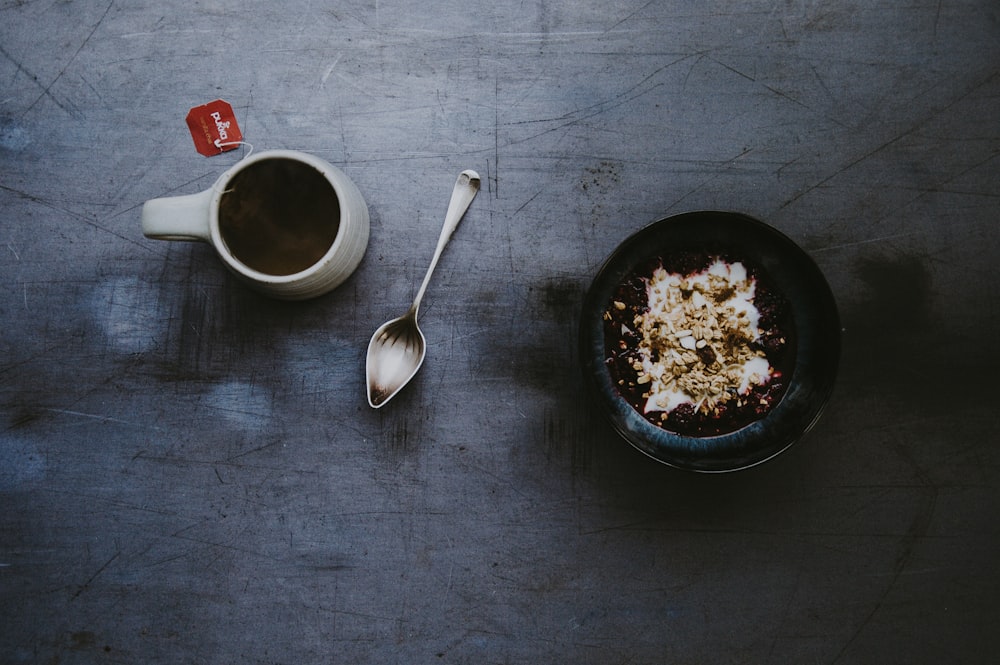 white ceramic mug and black bowl on top of table