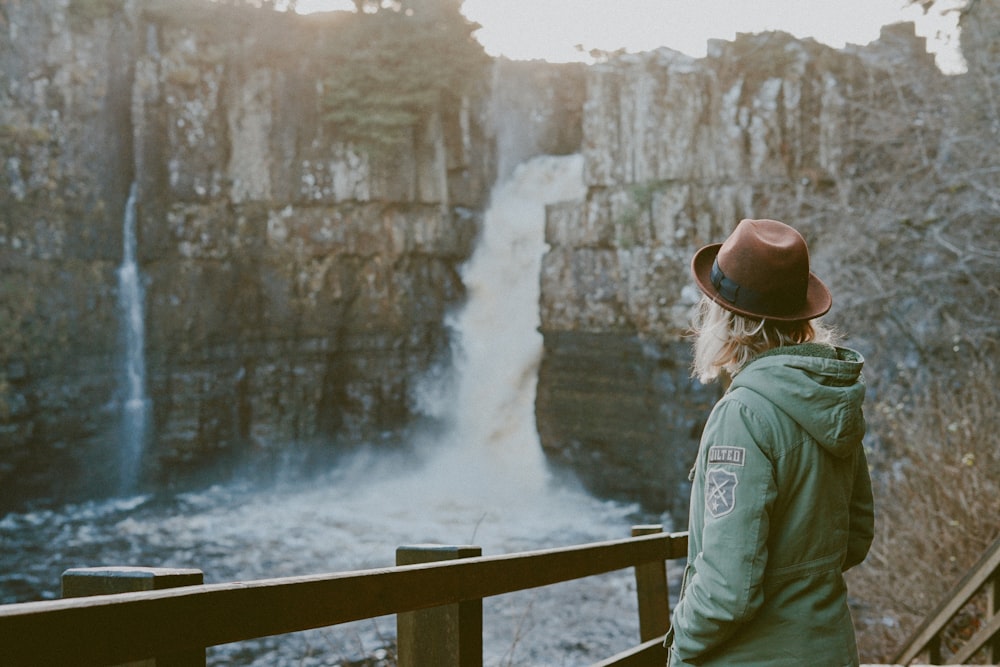 woman standing near waterfalls