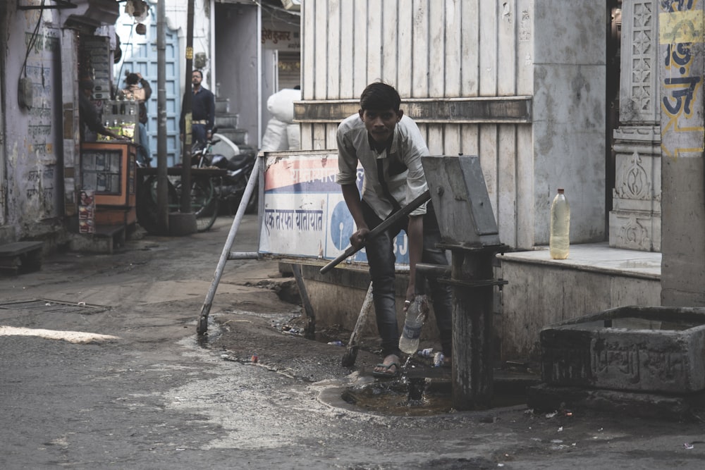 man pumping water on water pump