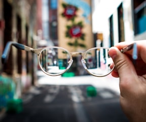 person holding eyeglasses