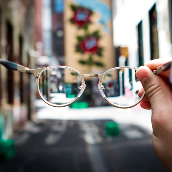 person holding eyeglasses