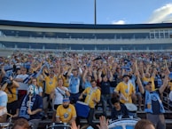 Fan wearing an Atlético Nacional green and white jersey cheering in the stadium
