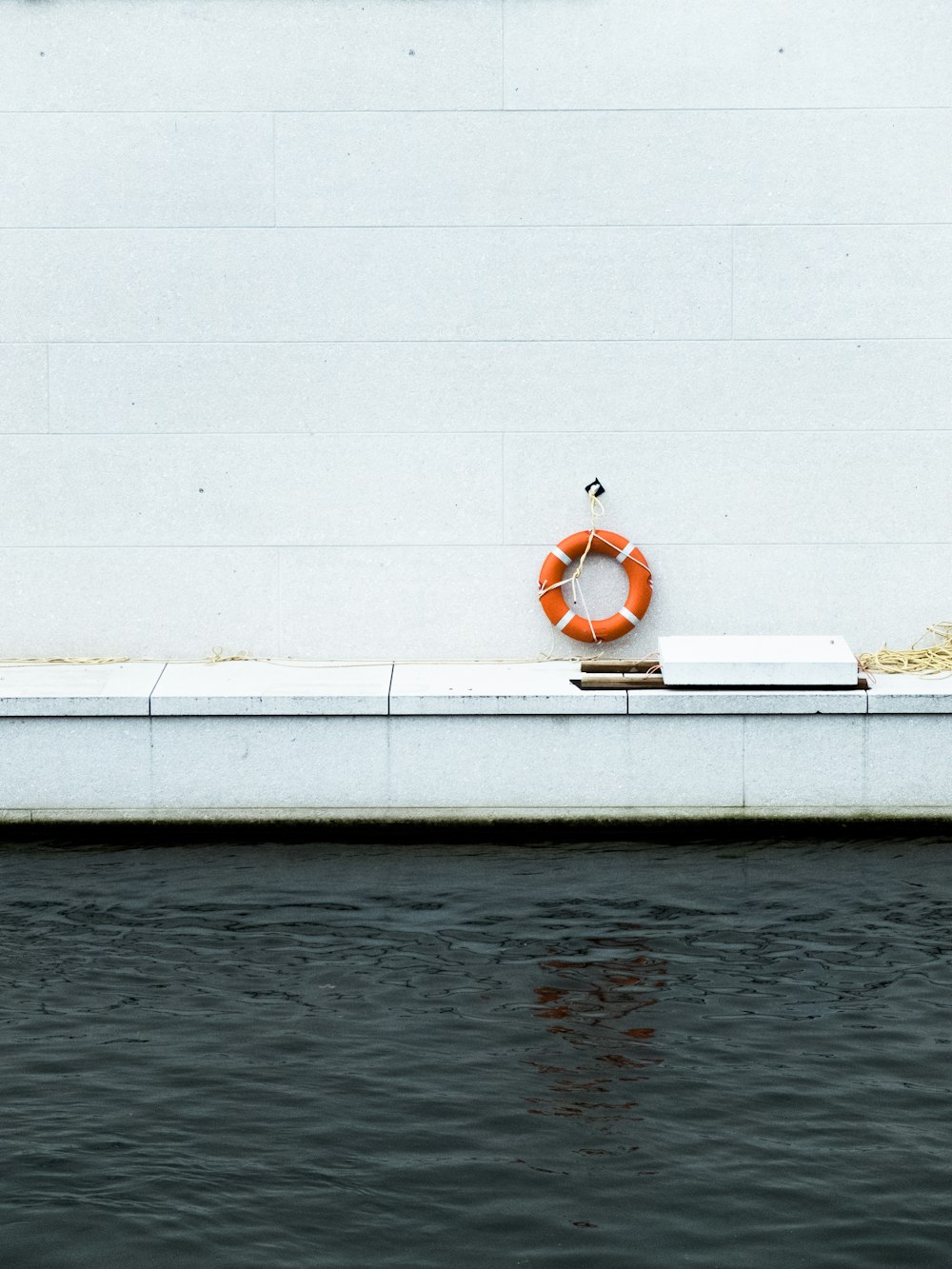 hanged orange life ring near pool