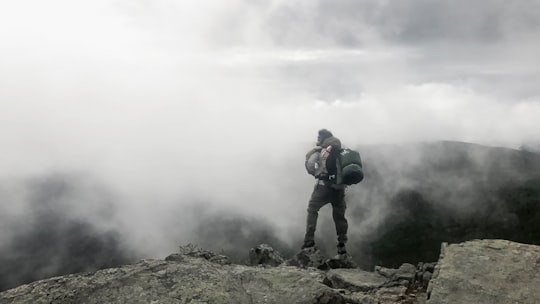 person carrying black hiking bag in New Hampshire United States