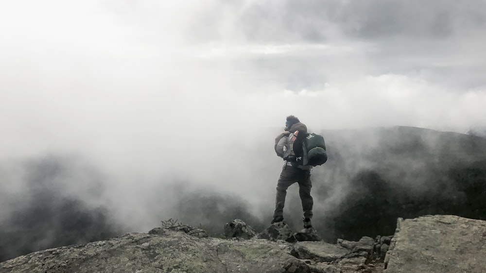 person carrying black hiking bag