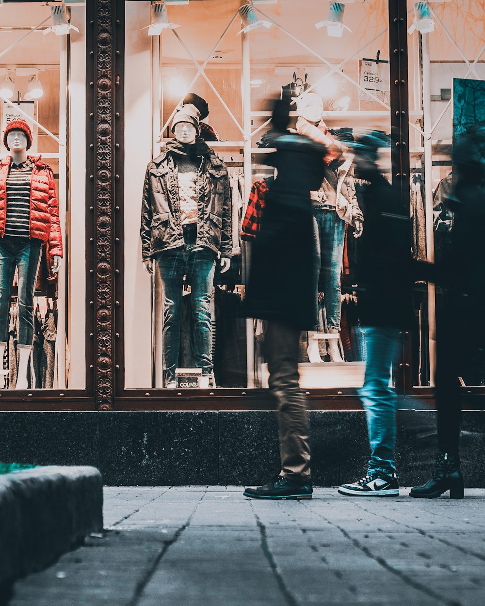 people watching manequins wearing jackets