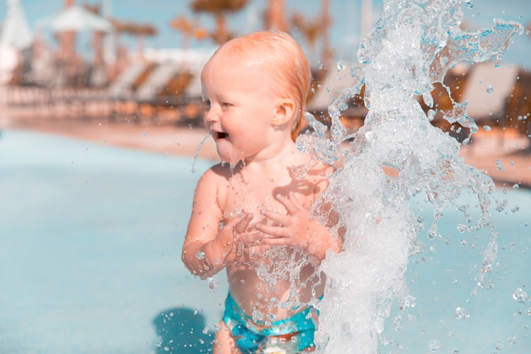 Young child playing in water at a water park