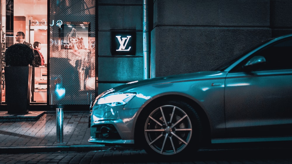 gray car parked beside Louis Vuitton store