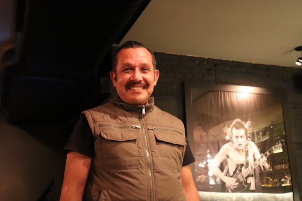 Portrait of Pablo smiling warmly in a casual office setting.