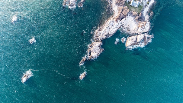 An aerial view of a coastal home surrounded by water.