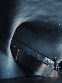 man standing on escalator