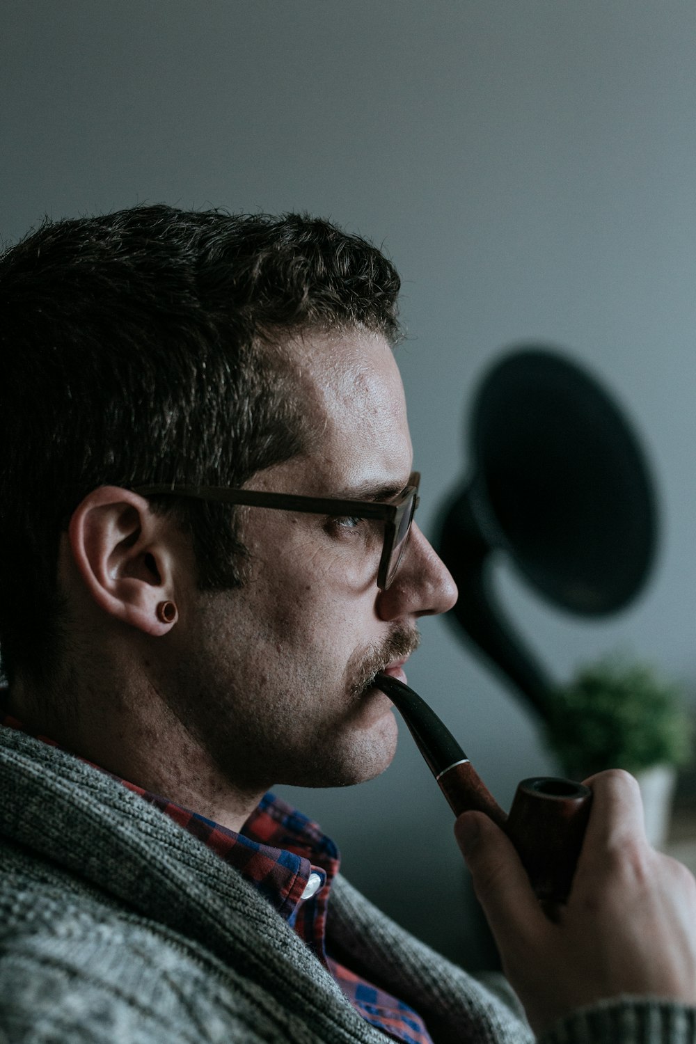 man holding tobacco pipe