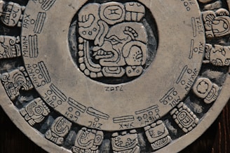 Mayan calendar stone showing intricate glyphs and celestial cycles.