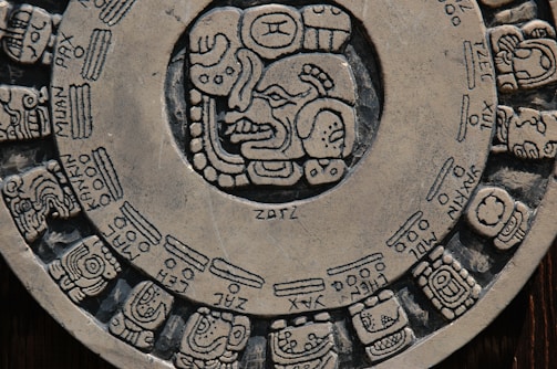 Mayan seal carved on stone with vibrant colors.
