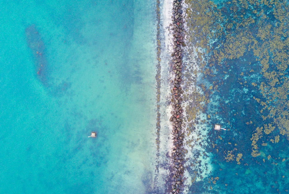 aerial photography of rock beside body of water