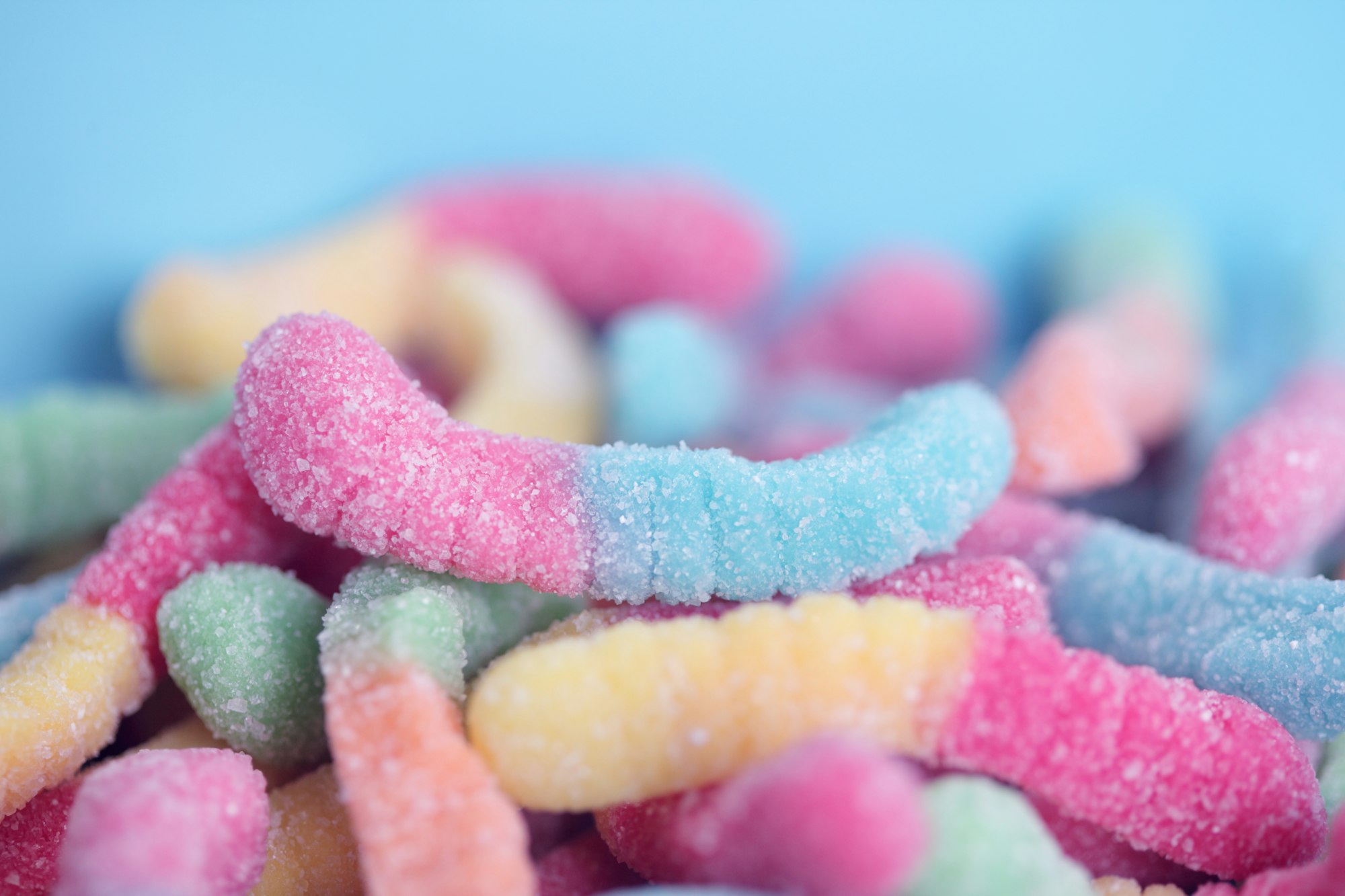 Close up image of sweet and sour gummy worms.
