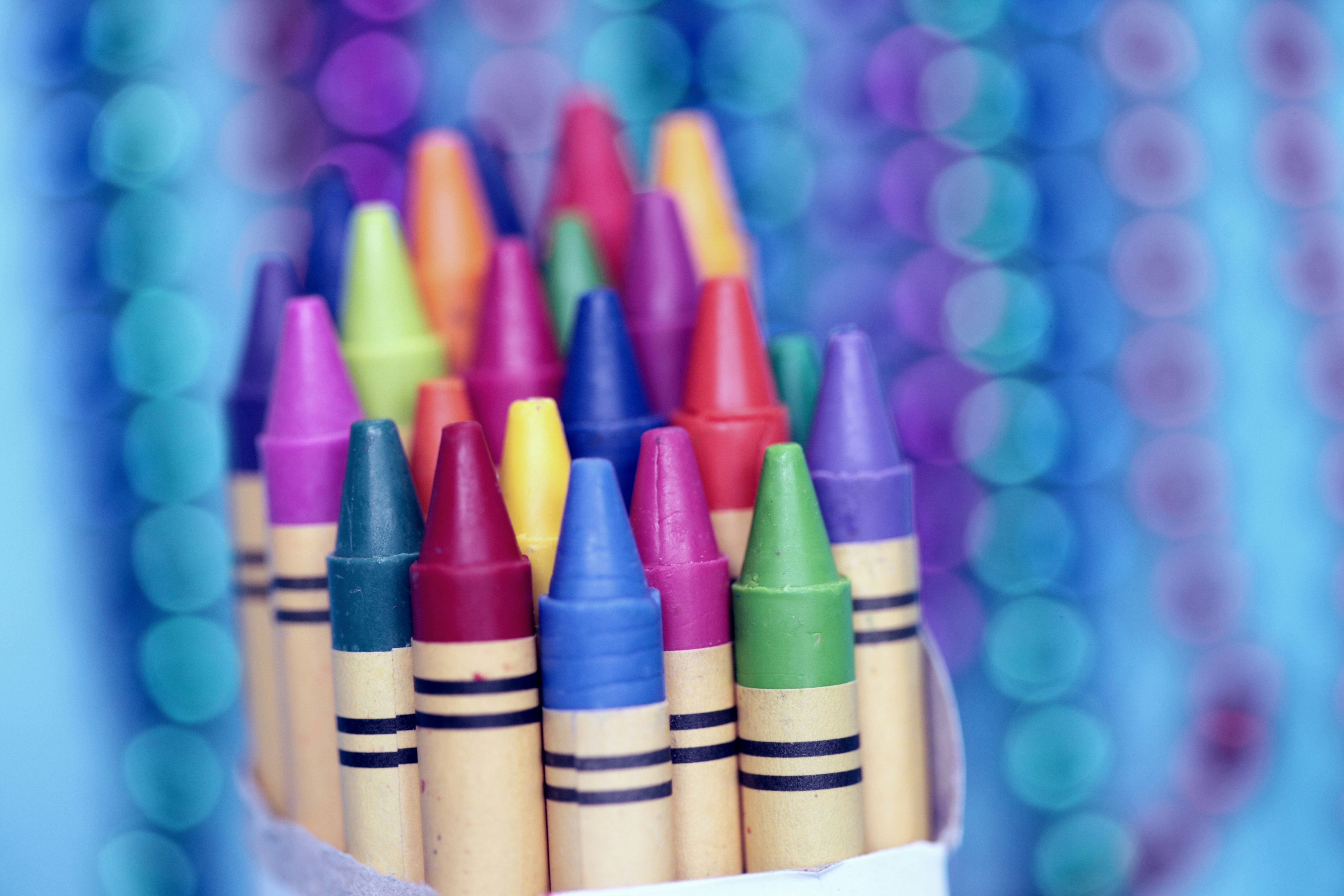 The lovely bokeh in the background was made by hanging strings of colorful beads behind the box of crayons.