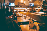 A cozy dining table set with warm lighting, ready for a family meal at Abes Restaurant Group.