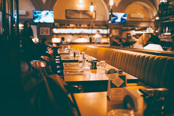 Cozy interior of Abes Restaurant Group LLC with warmly lit tables and happy families dining together.