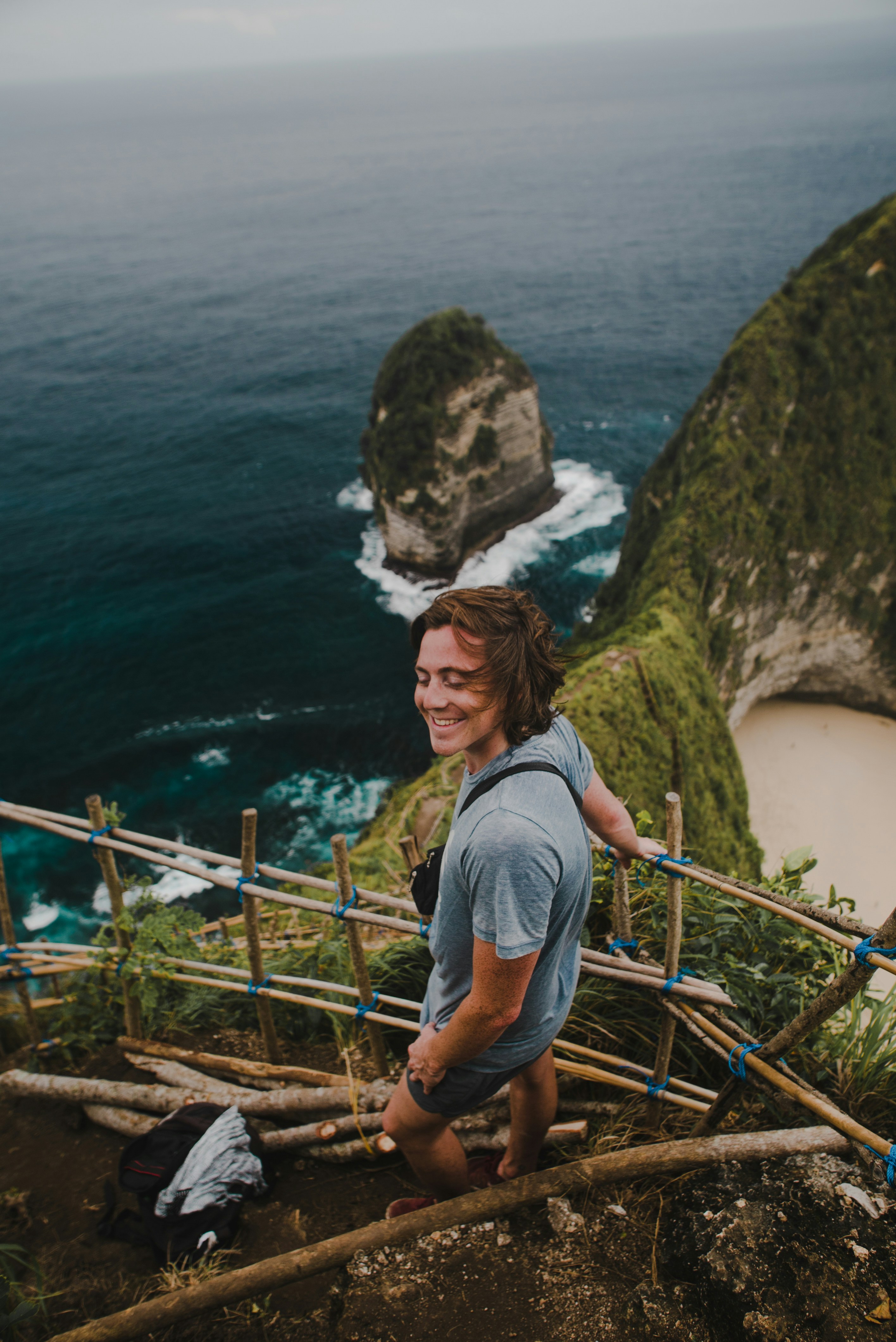 man wearing gray shirt and gray shorts standing on brown dirt