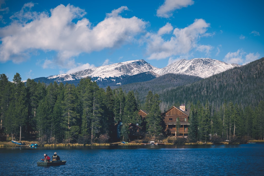 two person riding boat on calm body of water