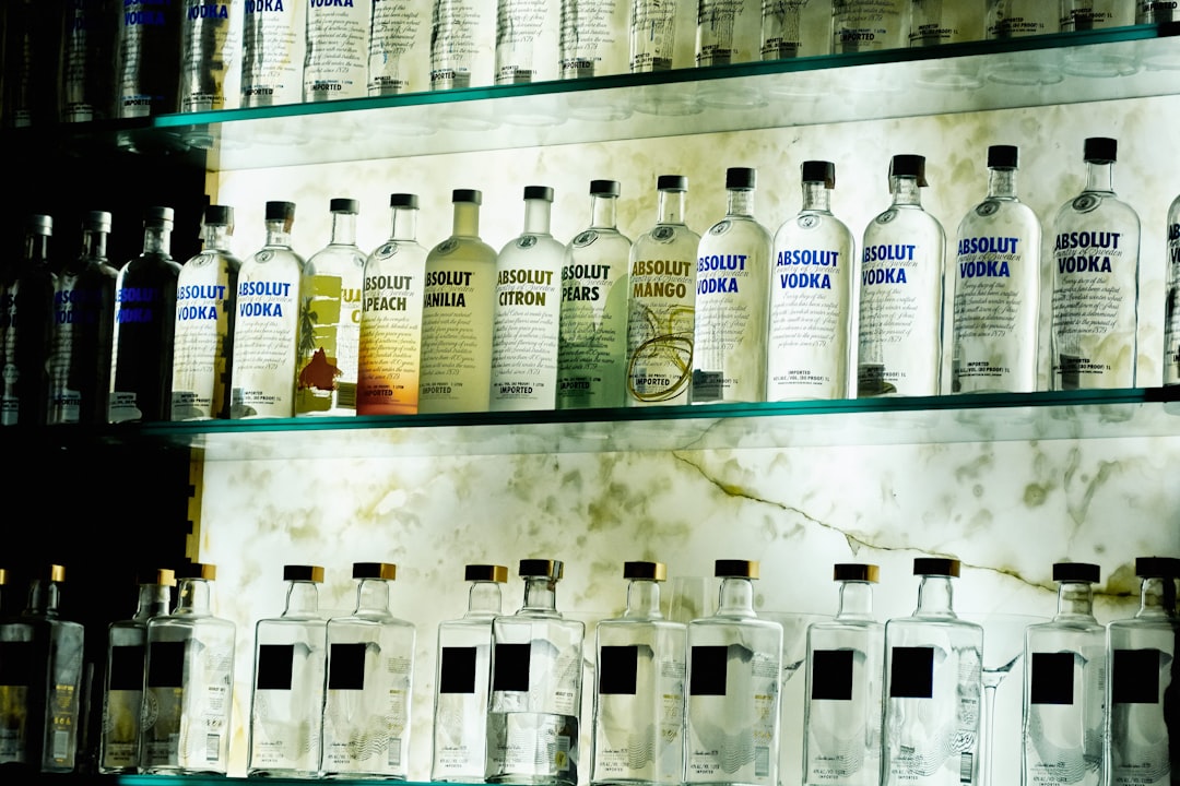 Absolute Vodka bottle lot on glass racks,