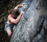 a man climbing up the side of a mountain