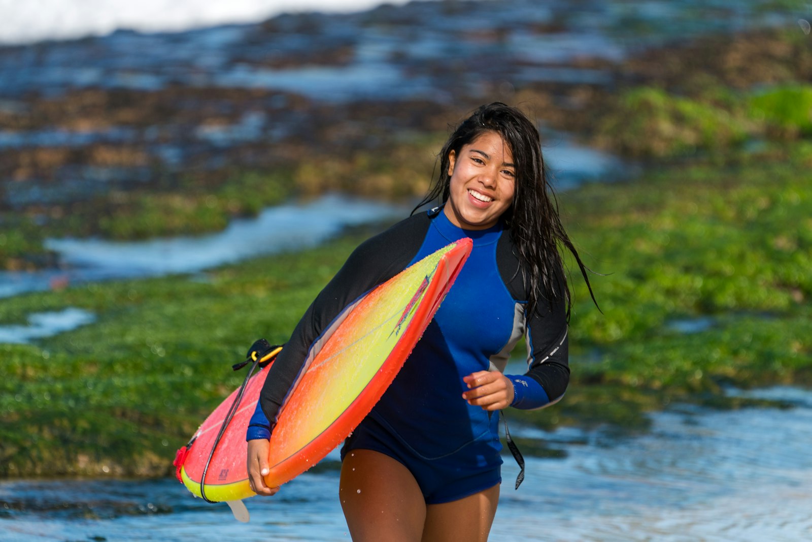 Sony a9 sample photo. Smiling woman carrying surfboard photography