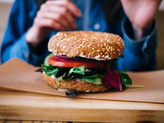Close-up of a wholesome sandwich with whole grain bread and fresh greens.