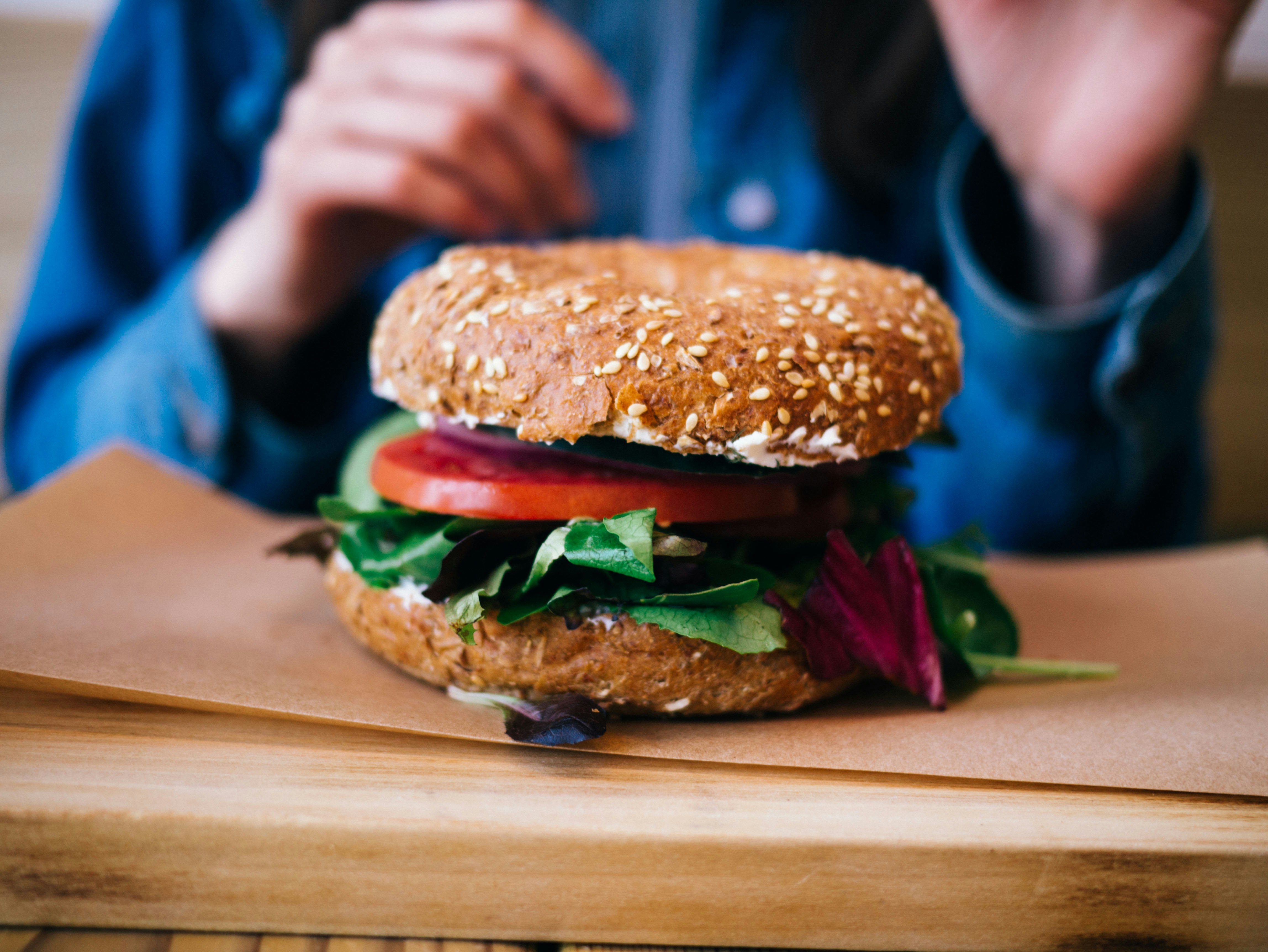 tilt photography of burger on brown pad