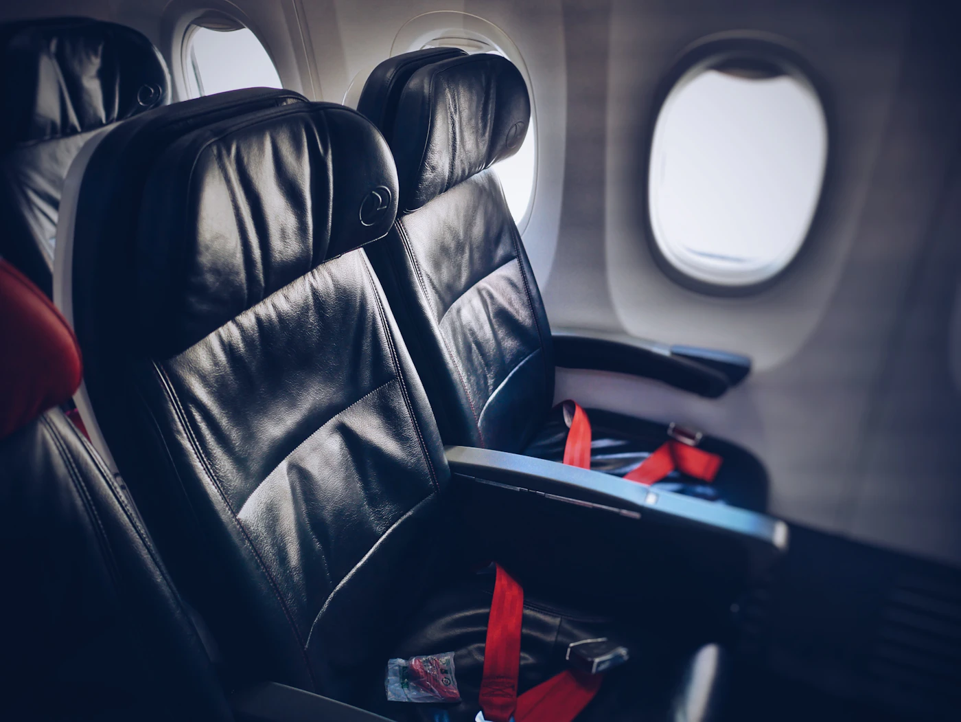 Premium-cabin seat by the window, where fare buckets, not discounts, decide what a long-haul flight costs