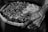 grayscale photography of person holding tray with candle lot