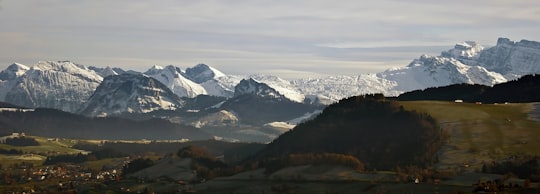 snow-covered mountains under gray clouds during daytime in Hirzel Switzerland