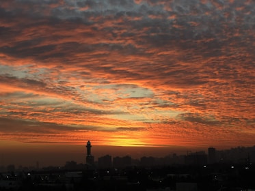 A completed jigsaw puzzle featuring a vibrant city skyline at sunset.