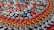 An assortment of colorful bottle caps neatly arranged in rows, showcasing various beverage brands. The caps include vibrant colors and recognizable logos from popular drinks like Coca-Cola, Fanta, Amstel, Fix, and Heineken.