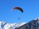 A joyful tandem paragliding flight over Cerro Arco with clear skies and mountain views.
