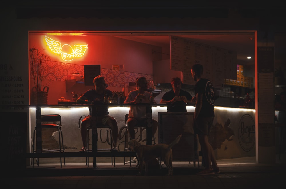 a group of people sitting at a bar