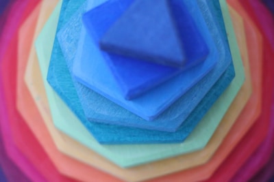 An assortment of colorful yoga blocks stacked together.