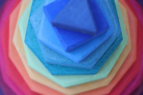 Close-up of colorful stacking blocks with smooth edges and muted tones.