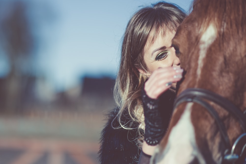 woman petting horse