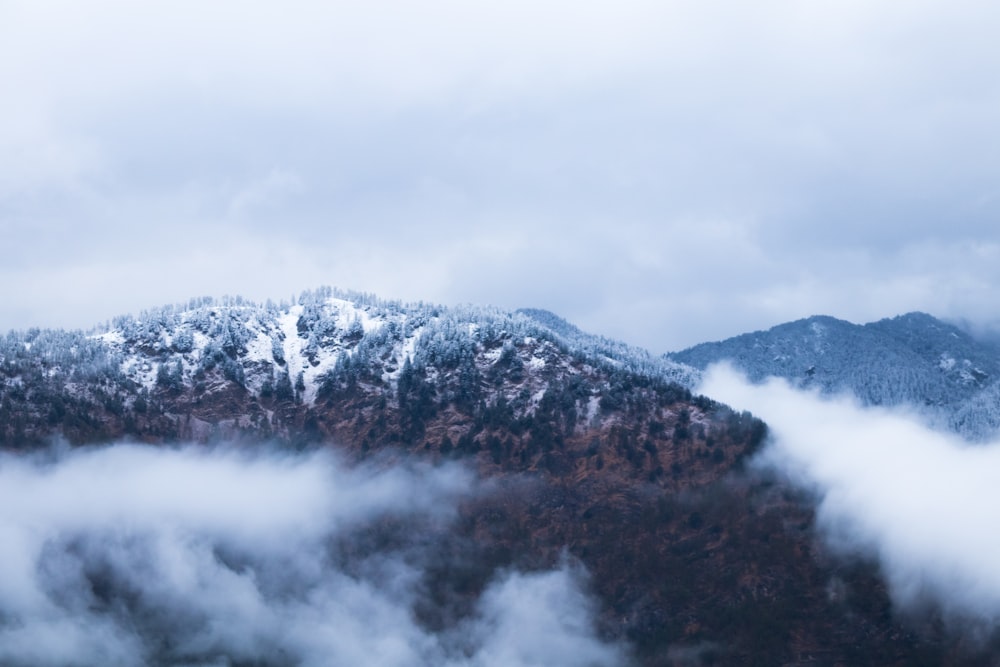 birds-eye view of mountain covered with clouds