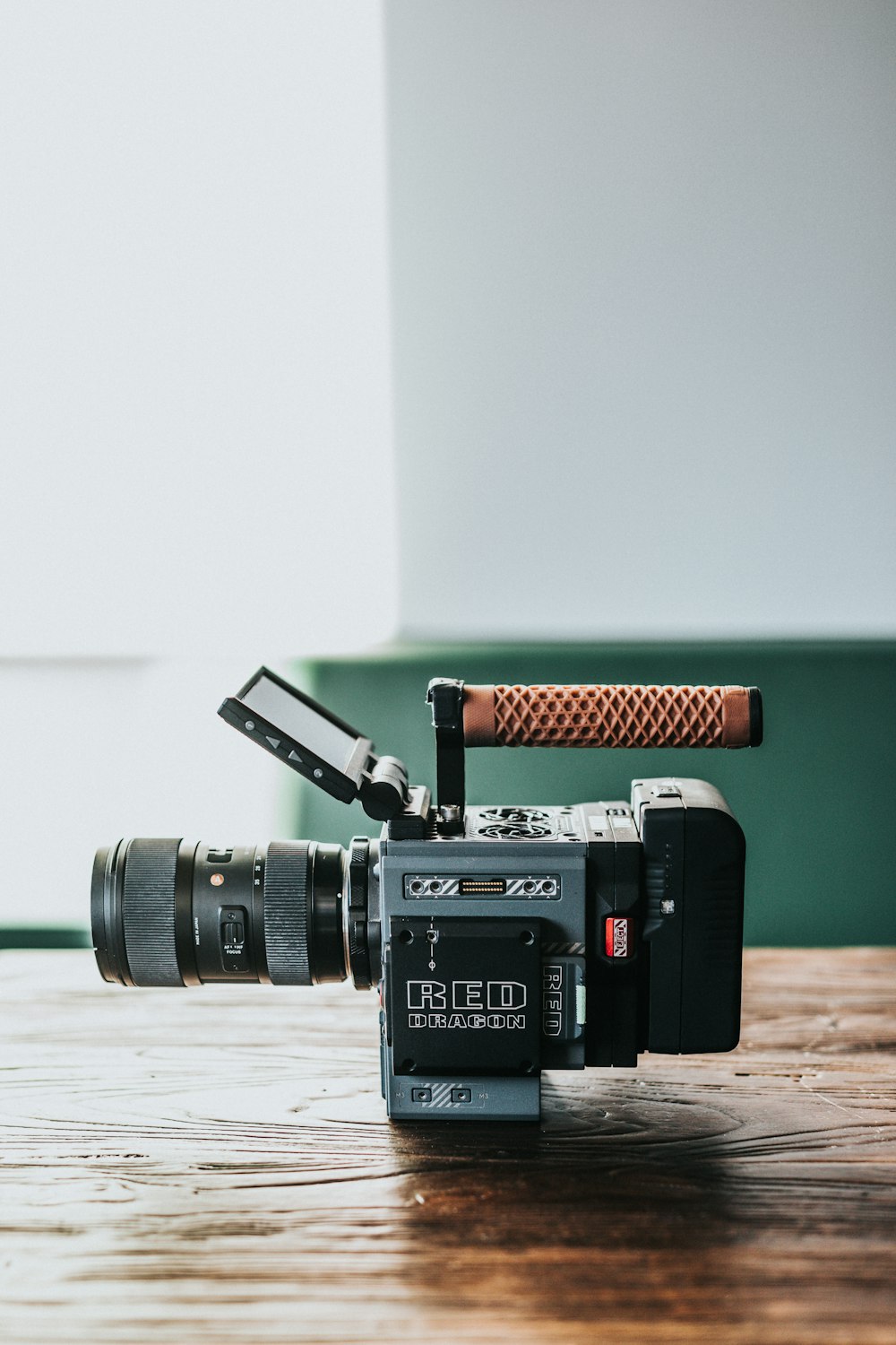 black and grey camera on wooden table