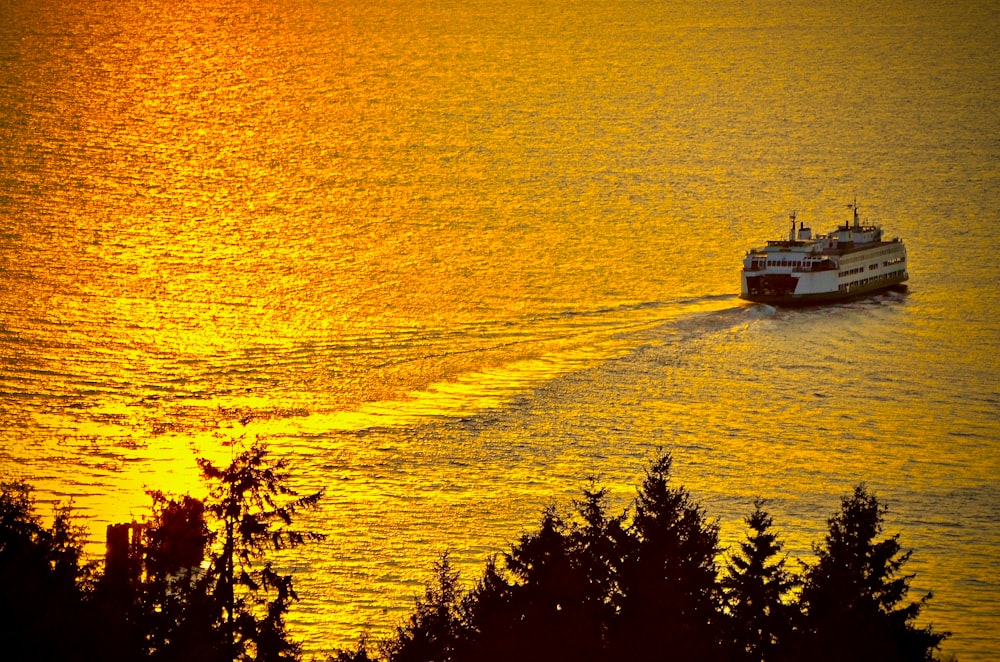 white boat sailing on water