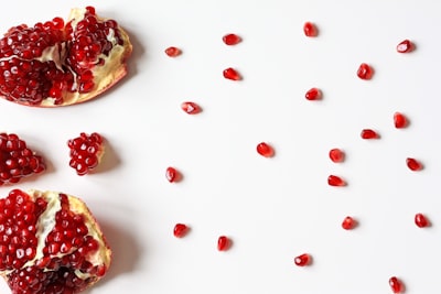 closeup photo of sliced pomegranate fruit tasteful teams background