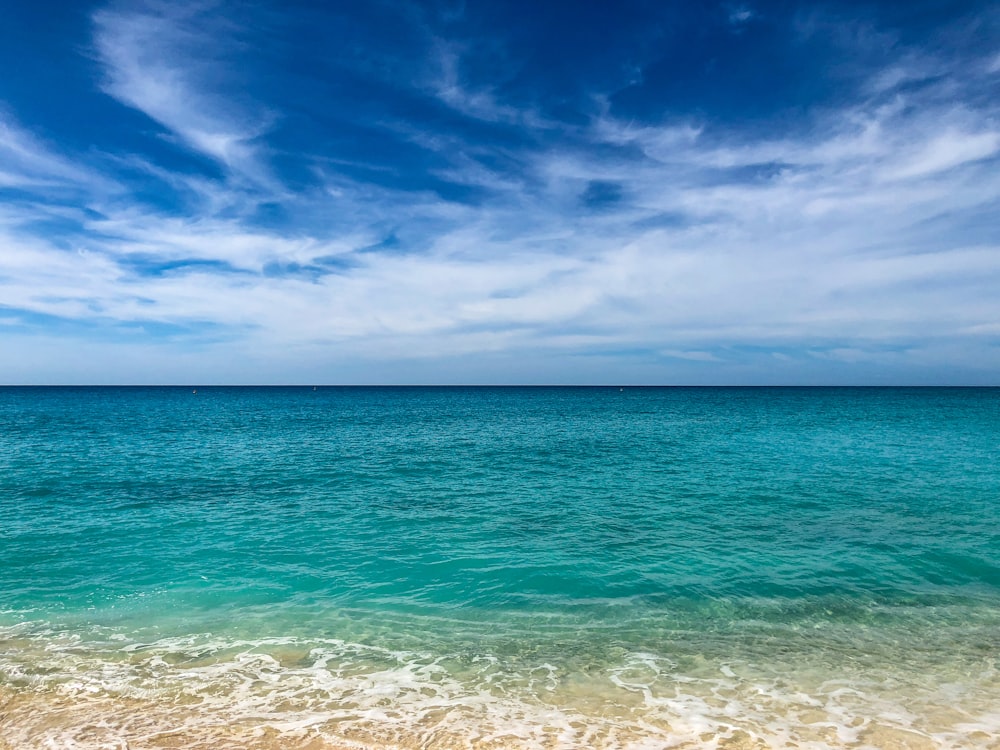 landscape photography of body of water under blue sky