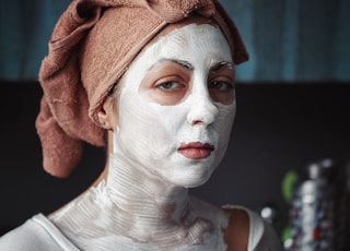 shallow focus photography of woman having a facial